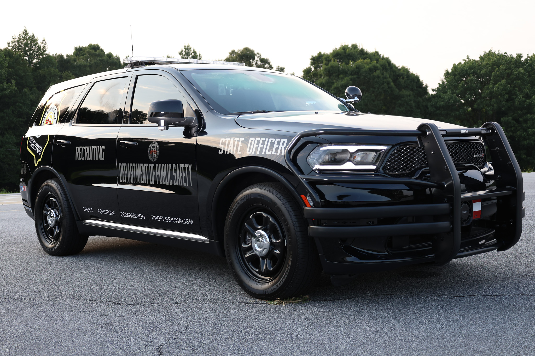 Black Georgia CVE SUV marked Recruiting and State Officer, with Trust, Fortitude, Compassion, and Professionalism lettered on the side