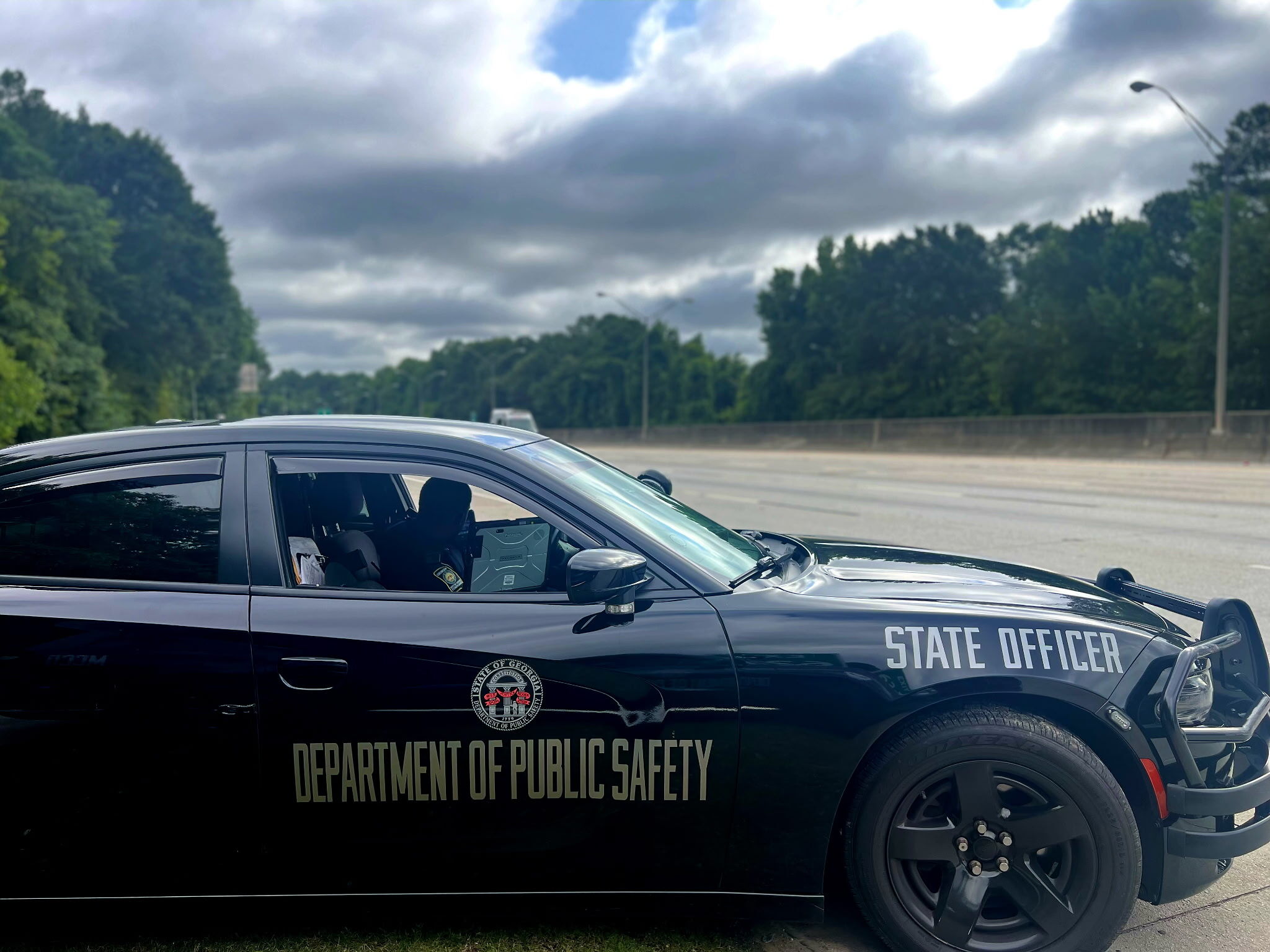 Georgia Department of Public Safety patrol vehicle marked State Officer parked on the shoulder of a highway