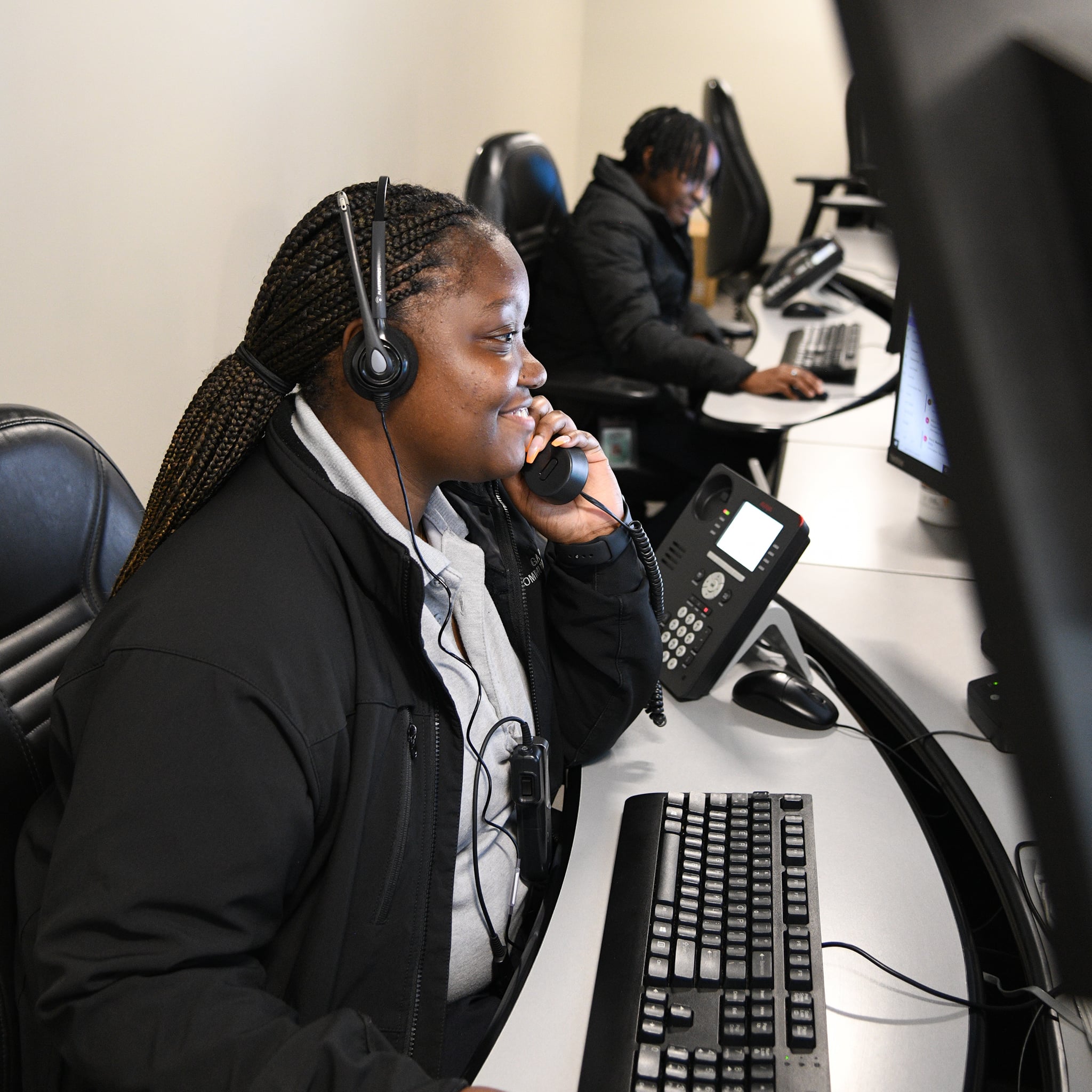 DPS dispatcher on headset at communications console